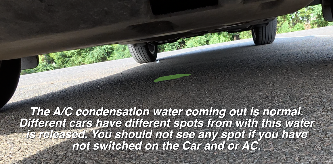 Using a torch to check under a new car's engine bay for fluid leaks