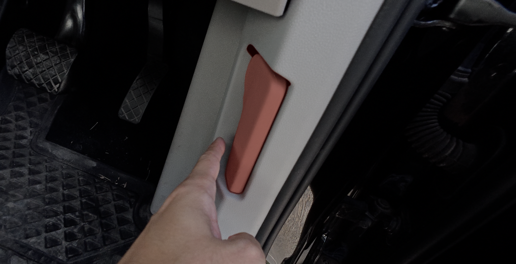 Bonnet release lever on the driver's side footwell of a new car